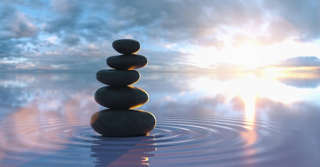 Japanese zen garden stacks of pebbles in the wide ocean at sunset