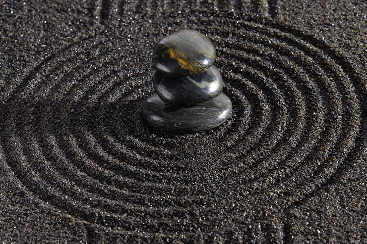 Photo japanese zen garden with stacked stones in textured  sand