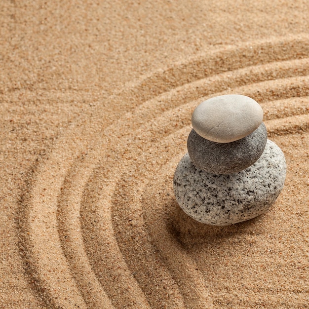 Japanese Zen stone garden relaxation meditation simplicity balance concept pebbles and raked sand