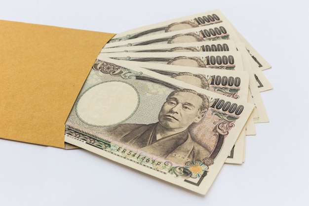 Japans bankbiljet 10.000 Yen in bruine envelop voor geven en bedrijfssucces en het winkelen.
