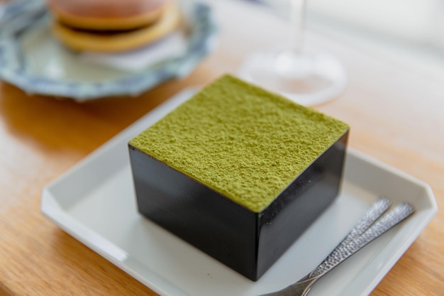 Foto japanse matcha tiramisu in houten doosje met sake en matcha siroop met latte dorayaki selectief f