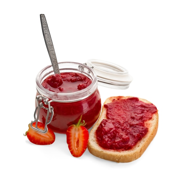 Jar and bread with strawberry jam on white background