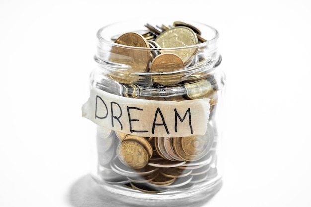 A jar of coins with the word dream written on it