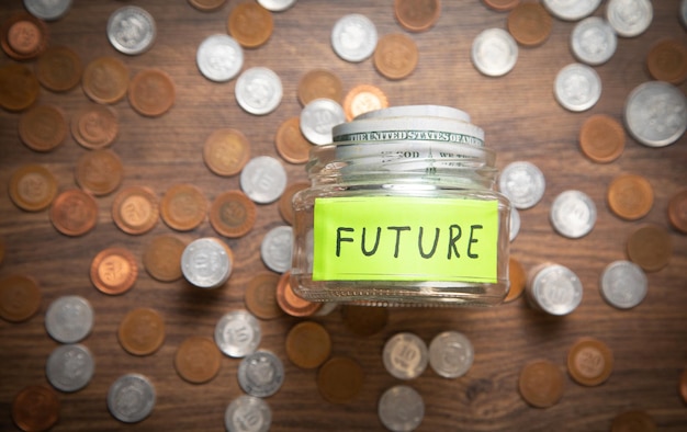 Jar of coins and word Future Concept of saving money for future