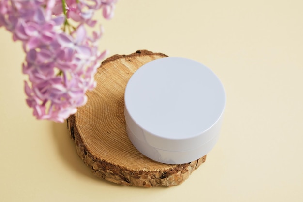 jar of cosmetics without logo and label blank product mocap and lilac branches