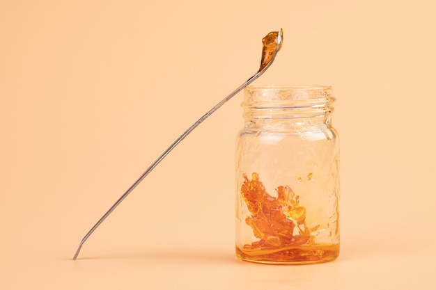 A jar and dab stick of cannabis resin for smoking with a high content of THC