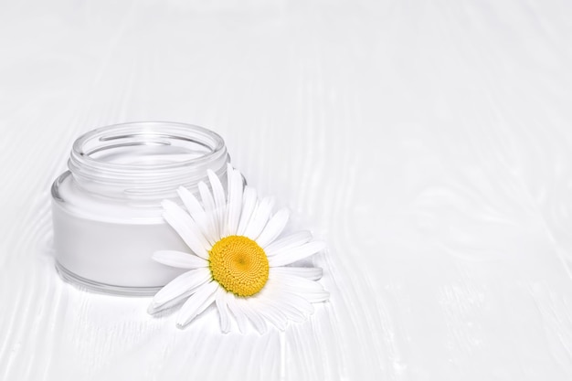 A jar of face cream on white background