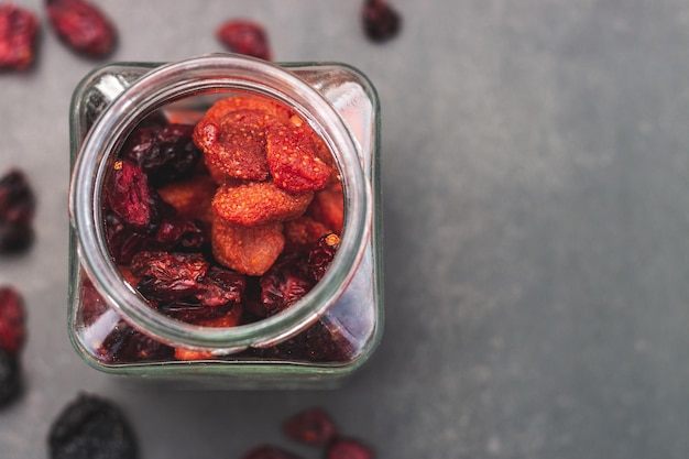 Jar full of berries with black background