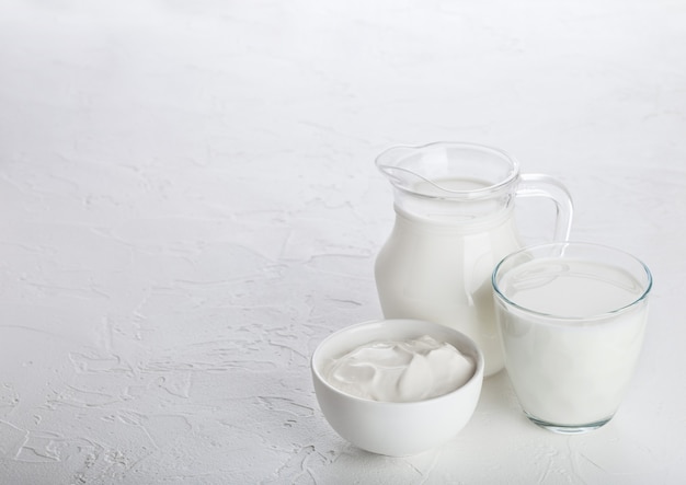 Jar and glass of milk and bowl of sour cream