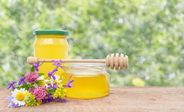 A jar of herbal honey on a wooden bar