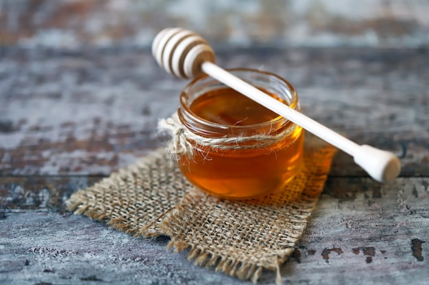 Jar of honey and a dipper for honey.