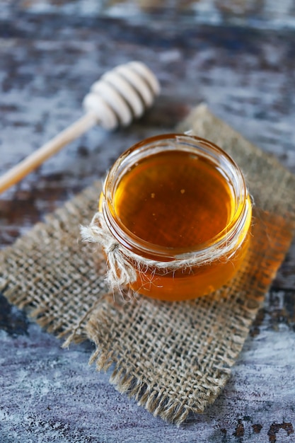 Jar of honey and a dipper for honey.