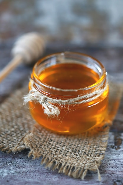 Jar of honey and a dipper for honey.