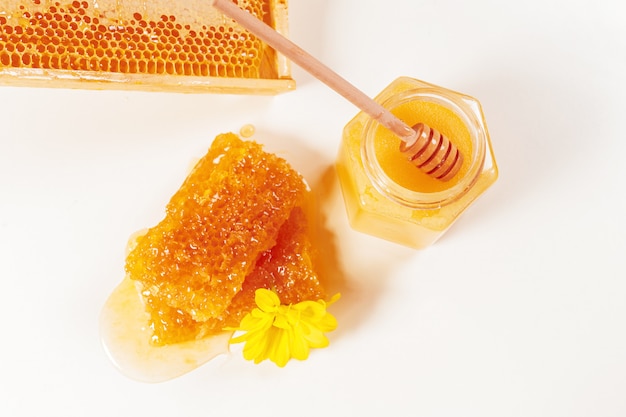 Jar of honey and stick isolated