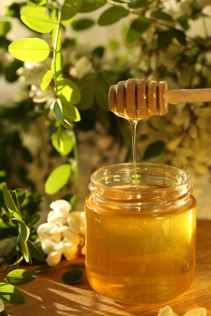 jar of honey with white flowers blossom