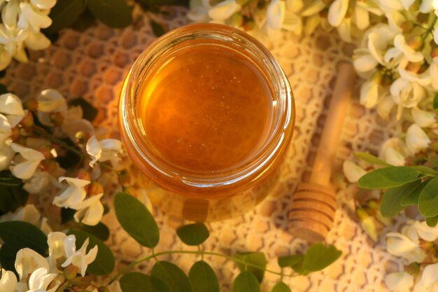 jar of honey with white flowers blossom
