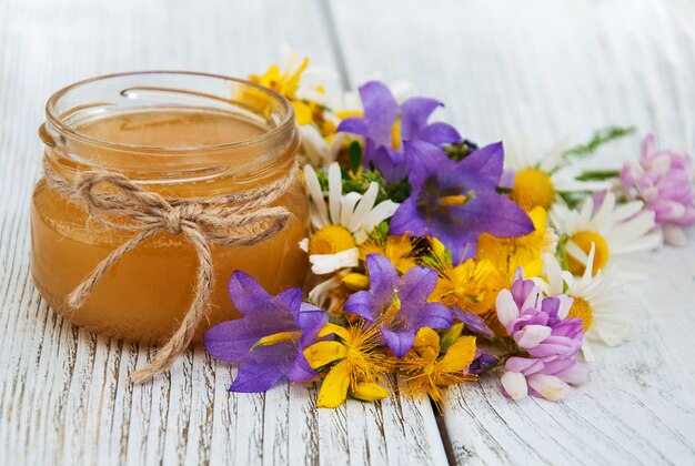 Jar of honey with wildflowers