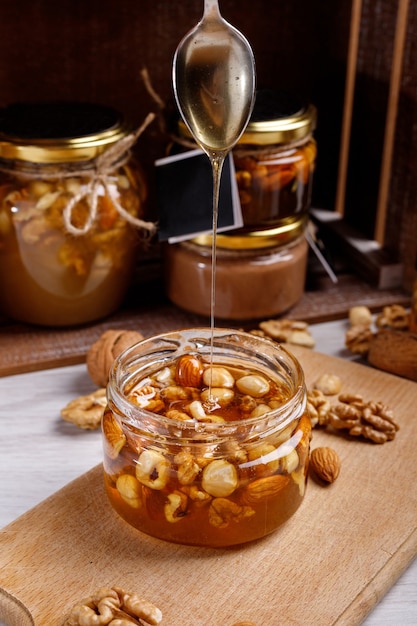 Jar of honey on a wooden board