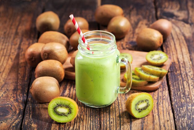 Jar of kiwi smoothie with fresh fruits