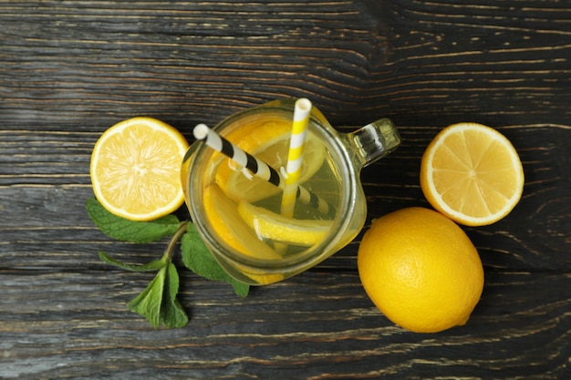 Jar of lemonade on wooden background, top view