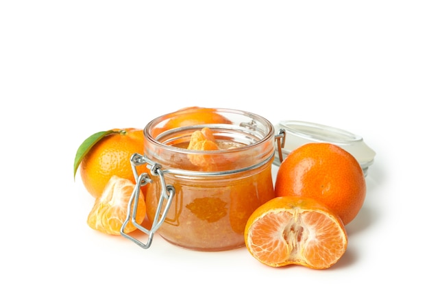 Jar of mandarin jam and ingredients isolated on white background