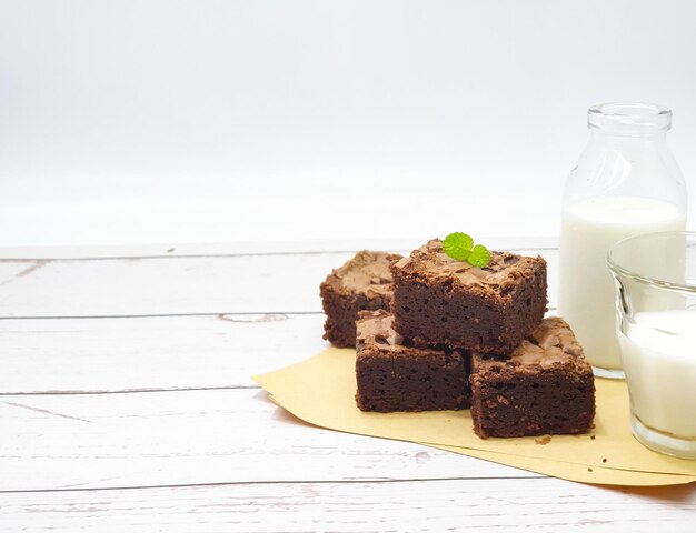 A jar of milk with three brownies on it