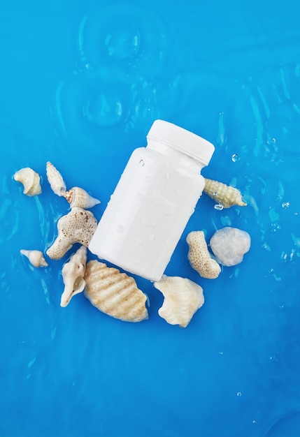 Jar mockup on blue background in water with waves and seashells