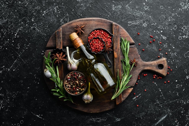 Jar of olive oil with spices on a dark background Top view Free space for your text