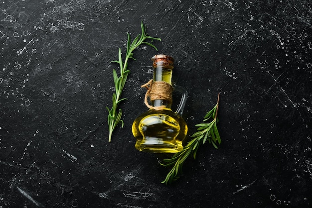 Jar of olive oil with spices on a dark background Top view Free space for your text