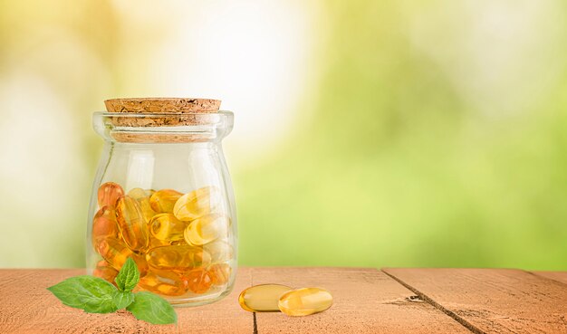 A jar of omega-3 capsules on a wooden table