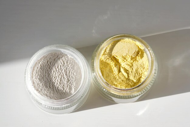 A jar of rice flour face scrub and a jar of turmeric face scrub