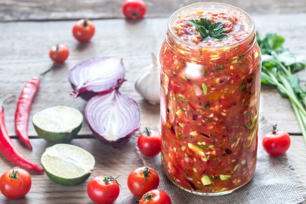 Jar of salsa with ingredients