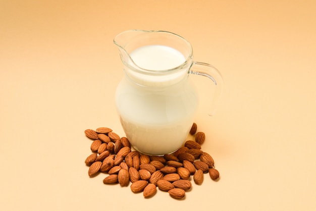 Jar with almond milk and almonds next to it