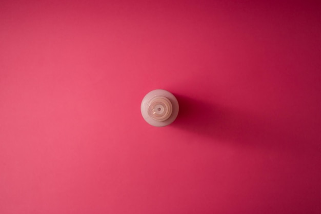 Jar with antiseptic on a pink background