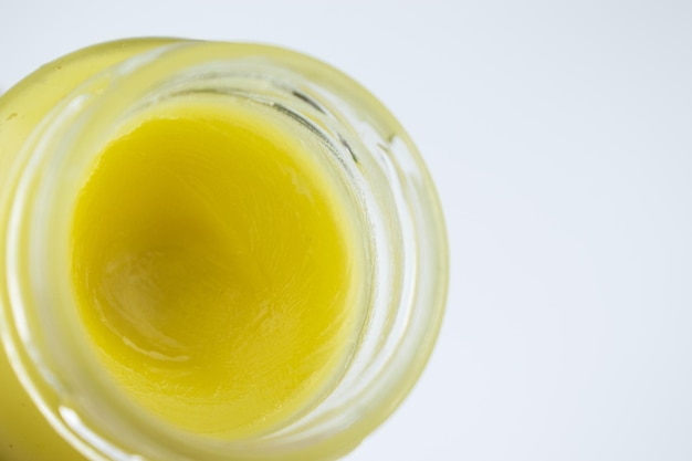 A jar with balm cream on a light background