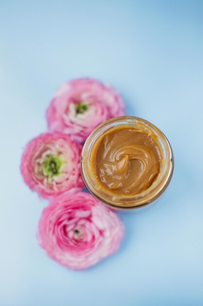 Jar with caramel and pink flowers