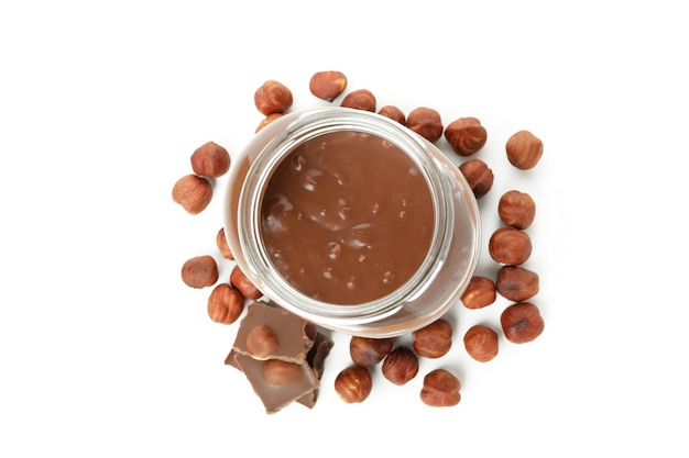 Jar with chocolate paste and nuts isolated on white background