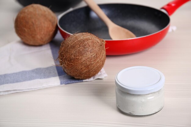 Photo jar with coconut oil on table