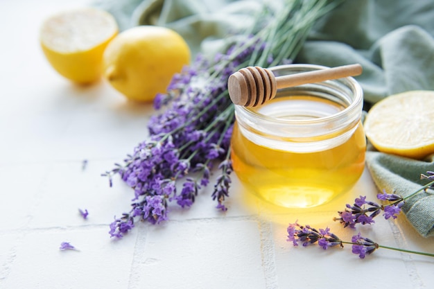 Jar with honey and fresh lavender flowers