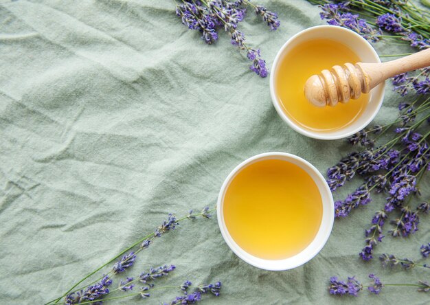 Jar with honey and fresh lavender flowers