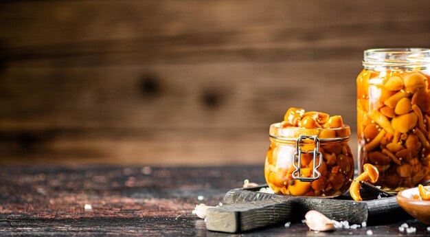 Jar with marinated mushrooms on the table