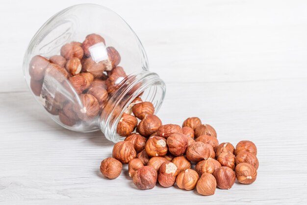 Jar with  nut on white wood table