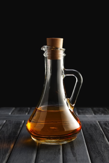 Jar with oil on wooden table