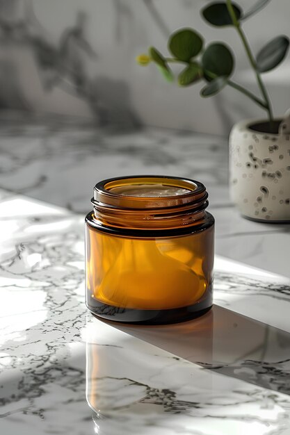 A jar of yellow liquid sitting on a marble counter top next to a potted plant with a single flower