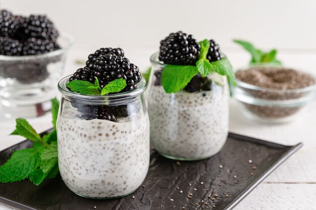 Jars of chia pudding with mint and fresh berries. Superfoods concept