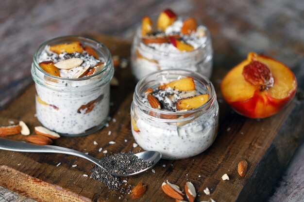 Jars of chia yogurt, peach and almonds