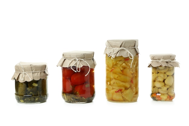 Jars of pickled vegetables isolated on white background