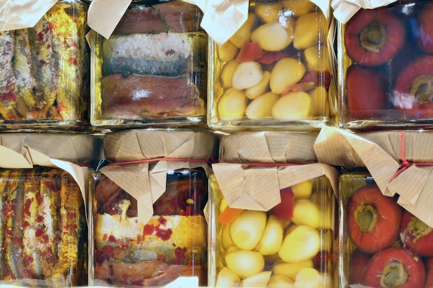 Photo jars of typical italian products preserved in oil with garli