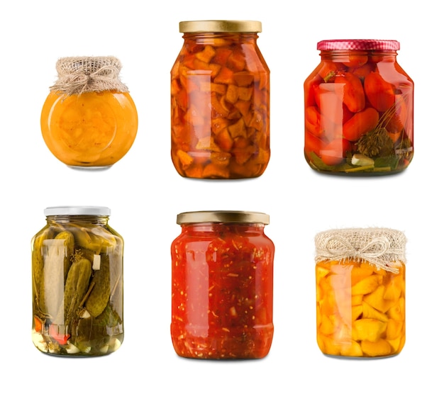 Jars with canned vegetables and jams on background