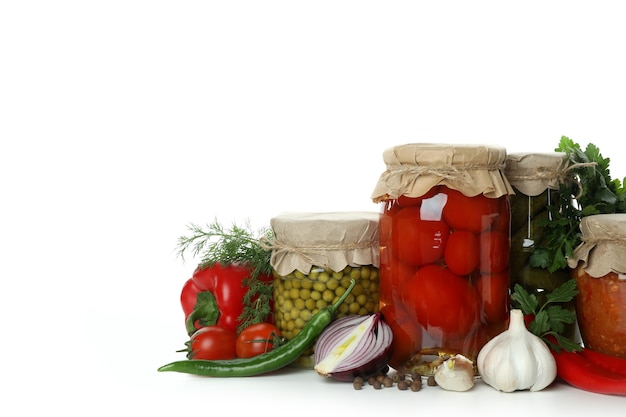 Jars with different canned food isolated on white